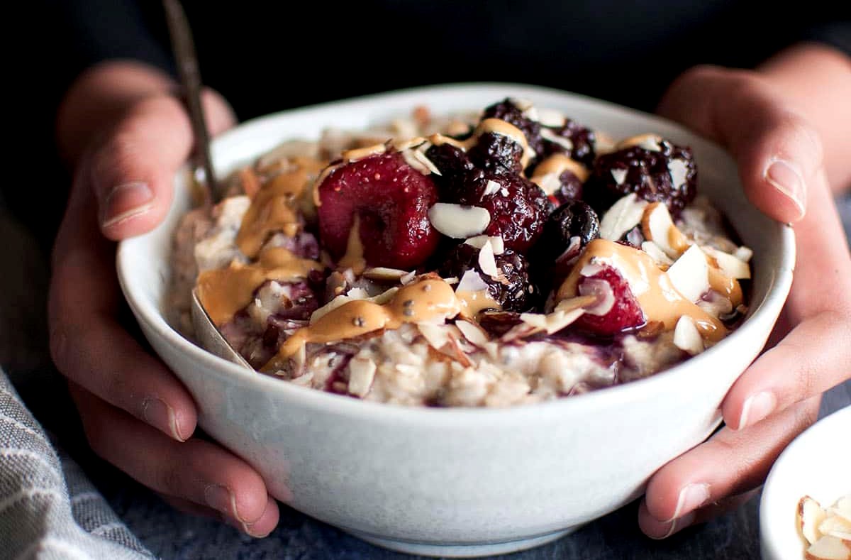 Warming Coconut, Chia & Ginger Porridge with  Hot Berries, Almond Butter & Toasted Crunch