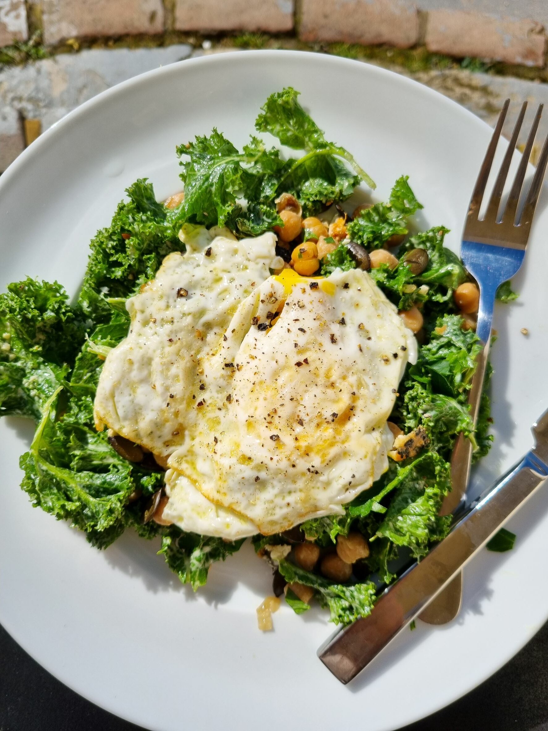 Chickpeas & Kale Massaged in Tahini & Olive Oil topped with Pumpkin Seeds & a Fried Egg