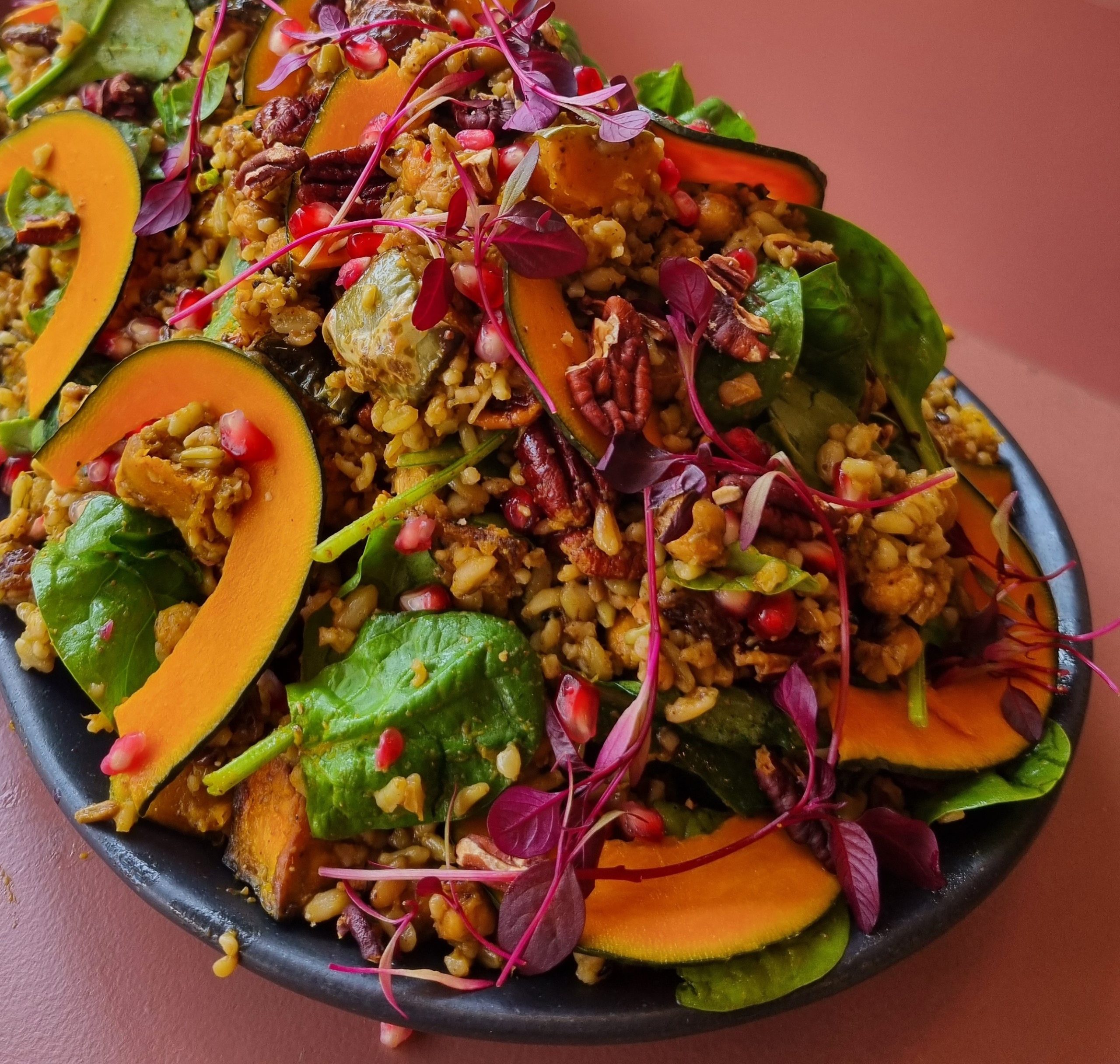 Autumnal Roasted Squash, Spinach and Freekeh Salad with Toasted Pecans, Raisins, Pomegranate seeds and a Date Vinaigrette Dressing